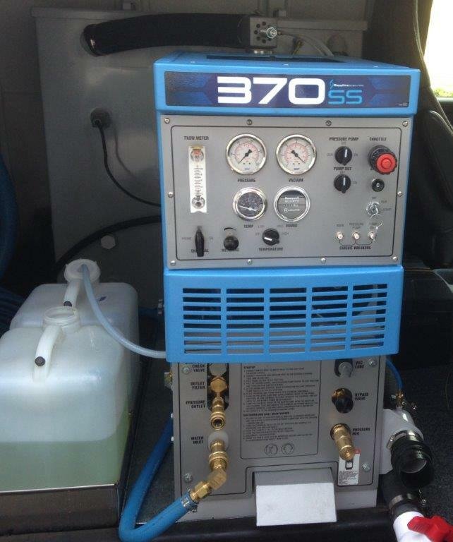 Truck-mounted carpet cleaning equipment vehicle parked outside Lake Geneva home